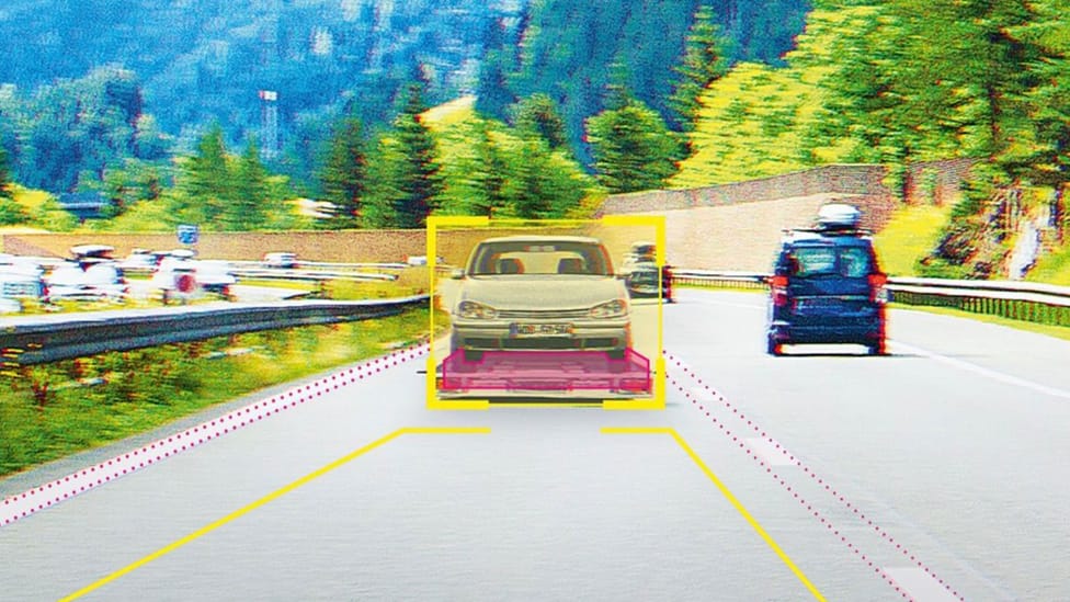 Graphic showing car being transported on the back of a flat-bed on the motorway, identified by camera sensors for ADAS safety modelling